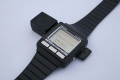 The WristMac on its 'bi-directional' Macintosh adapter. (Image source: Aroged)