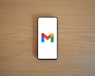 Smartphone showing the Gmail logo on a wooden table