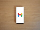 Smartphone showing the Gmail logo on a wooden table