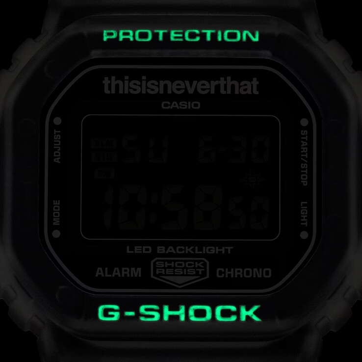 Glow-in-the-dark bezel markings on the Casio G-Shock DW-5600TNT-7 illuminating green in a dark environment.