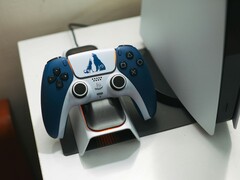 A custom God of War-themed DualSense controller resting on a charging dock in front of a PlayStation 5 console. (Image source: FOX ^.ᆽ.^= ∫)