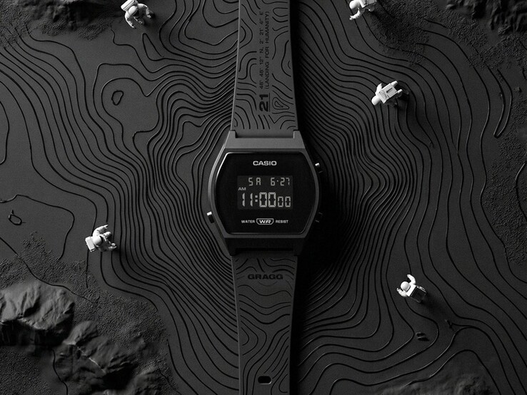 Close-up of the Casio x GRAGG LW-204GRAGG-1BDF showing its black resin strap with engraved contour-line graphics.