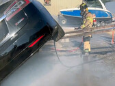 Sacramento firefighter putting out a combusting Model S (image: SFD)