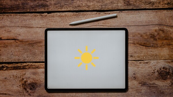 Go easy on your eyes by lowering the brightness on your iPad. (Image Source: Unsplash/Edited)
