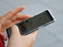 A hand holds an Android smartphone showing a map app.