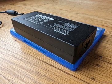 Medium-sized (~14.5 x 6.4 x 3 cm) 120 W external power brick