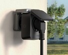 TP-Link Tapo P410M smart outdoor plug with its cover and cable connected to a wall socket. (Image source: TP-Link)