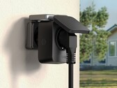 TP-Link Tapo P410M smart outdoor plug with its cover and cable connected to a wall socket. (Image source: TP-Link)