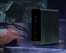 The OneXStation has launched without any formal announcements. Pictured: the mini PC on a desk next to a gaming monitor.