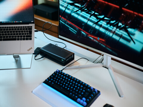 Aorus RTX 5060 Ti AI Box eGPU connected to a Lenovo ThinkPad X9 laptop running Cyberpunk 2077 on an external monitor.