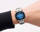 A Citizen Tsuno Chronograph with a blue gradient dial and stainless steel bracelet worn on a wrist against a white background.