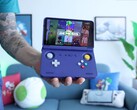 Retro Game Corps’ Russ holding the Retroid Pocket Flip 2 handheld gaming console in purple, with the screen displaying a Sega Genesis emulator interface. (Image source: Retro Game Corps on YouTube)