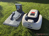 Robot lawn mower next to its charging station