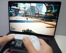 A person playing Cyberpunk 2077 on a MacBook using a DualSense controller, showcasing native gaming performance on macOS. (Image source: Andrew Tsai / YouTube)