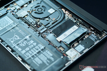 The ribbon cable for the keyboard deck (or Input Cover) sits between the battery and RAM modules