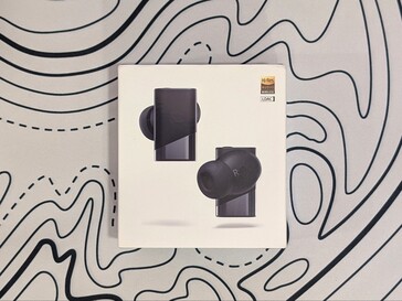 Retail packaging for the Status Pro X wireless earbuds.