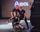 AIdol (pictured) stumbling on the stage, and the developers trying to catch it. (Image source: @Gerashchenko_en on X)