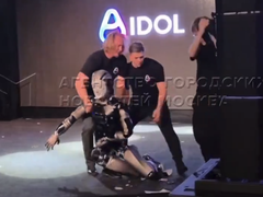 AIdol (pictured) stumbling on the stage, and the developers trying to catch it. (Image source: @Gerashchenko_en on X)