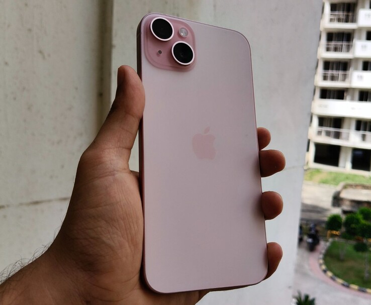 Apple iPhone 15 Plus in pink colour shown in hand during outdoor hands-on (Image source: Anmol Dubey)