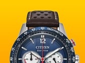 Close-up of the Citizen Racing Chronograph CA4716-09L, showing its blue tachymeter bezel, deep blue dial with silver-tone hands and markers, three subdials, red central seconds hand, and brown perforated leather strap against a yellow background.