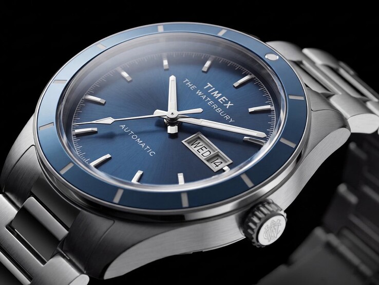 Close-up of the blue-dial Timex Waterbury Heritage Automatic showing its luminous hands, applied hour markers, and day-date display.