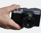 Fujifilm X-E4 compact interchangeable lens camera in hand