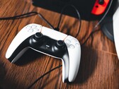 A picture of a PS5 controller next to a Nintendo Switch