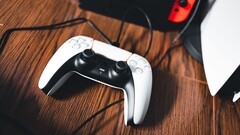 A picture of a PS5 controller next to a Nintendo Switch