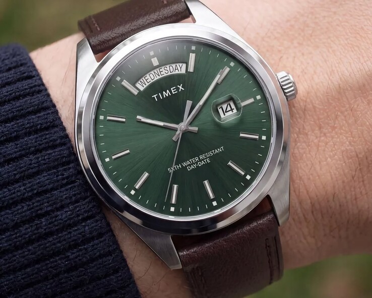 The Timex Legacy Day and Date on a wrist, featuring a green sunray diall.