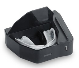 The mouthguard in its solo charging case (Image Source: Prevent Biometrics)