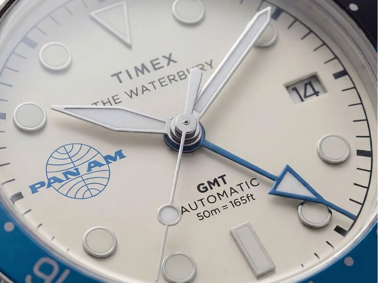 Close-up of the Timex Pan Am Waterbury Automatic GMT watch showing its silver-white dial, luminous hour markers, date window, and Pan Am branding.