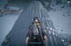 The scale of Talos-II makes itself clear as the Endministrator approaches a towering structure during the Process: Cold Start mission in Arknights: Endfield. 