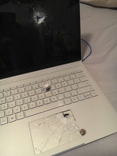 Twitter user Aaron&#039;s Surface Book after taking a bullet (Image source: @itsExtreme_)