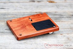 The underside has four small felt feet and a cavity covered by a plastic panel.