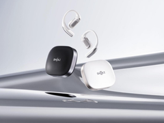 The Shokz OpenFit Pro (with case), pictured against a stylized silver background. (Image source: Shokz)