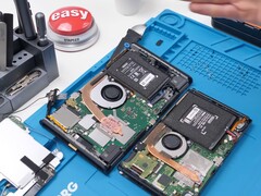 Teardown view of the Nintendo Switch 2 showing internal components including battery, fan, and mainboard (Image source: Phone Repair Guru on YouTube)