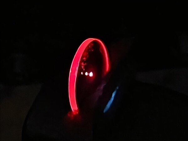A thin film emits red light from radical doublet excited state. (Image source: Biwen Li/Cavendish Laboratory, University of Cambridge; cropped)