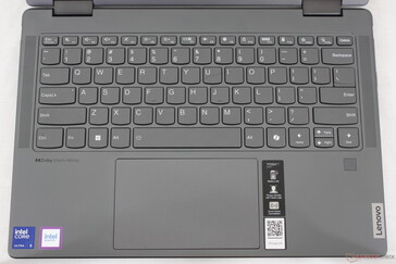 Keyboard layout includes speaker grilles down the sides whereas the Yoga 9 2-in-1 14 includes extra auxiliary keys instead