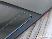 A shiny metal frame adorns the touchpad.