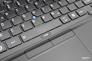 There is an AccuPoint mouse pointer between the keys.