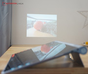 It projects pictures with up to 50 inches in diameter onto a wall.