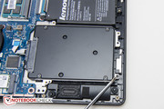 The SSD is secured with 4 Phillips screws.