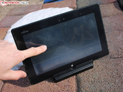 The touchscreen has an anti-glare coating, which reduces reflections, but doesn't completely prevent them.