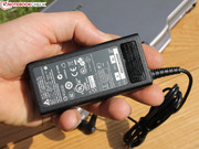 The 65 watts power adapter is quite small and it comes with a status LED.