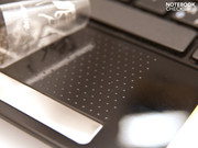 The knobby touchpad surface under the sticker