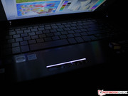 The work surface shimmers in the dark and the touchpad indicator show the way.