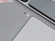The touchpad is disabled when a hand rests on the sensor beside it.