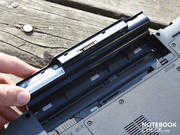 The battery is rolled out after releasing the latches.
