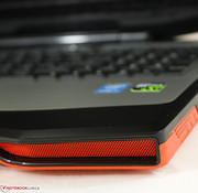 Matte black plastic and brushed aluminum inner surfaces contrast the bright orange