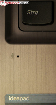 The microphone is located on the left side, below the keyboard.